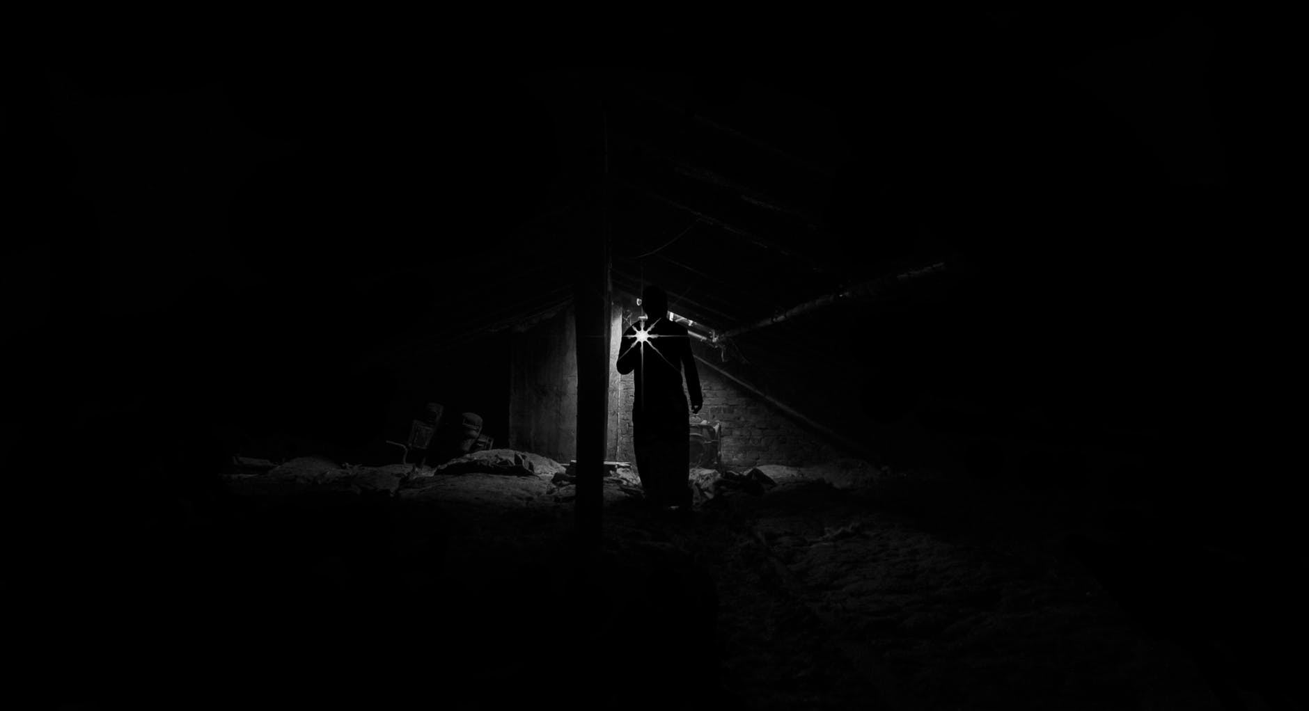 shadowy figure with flashlight